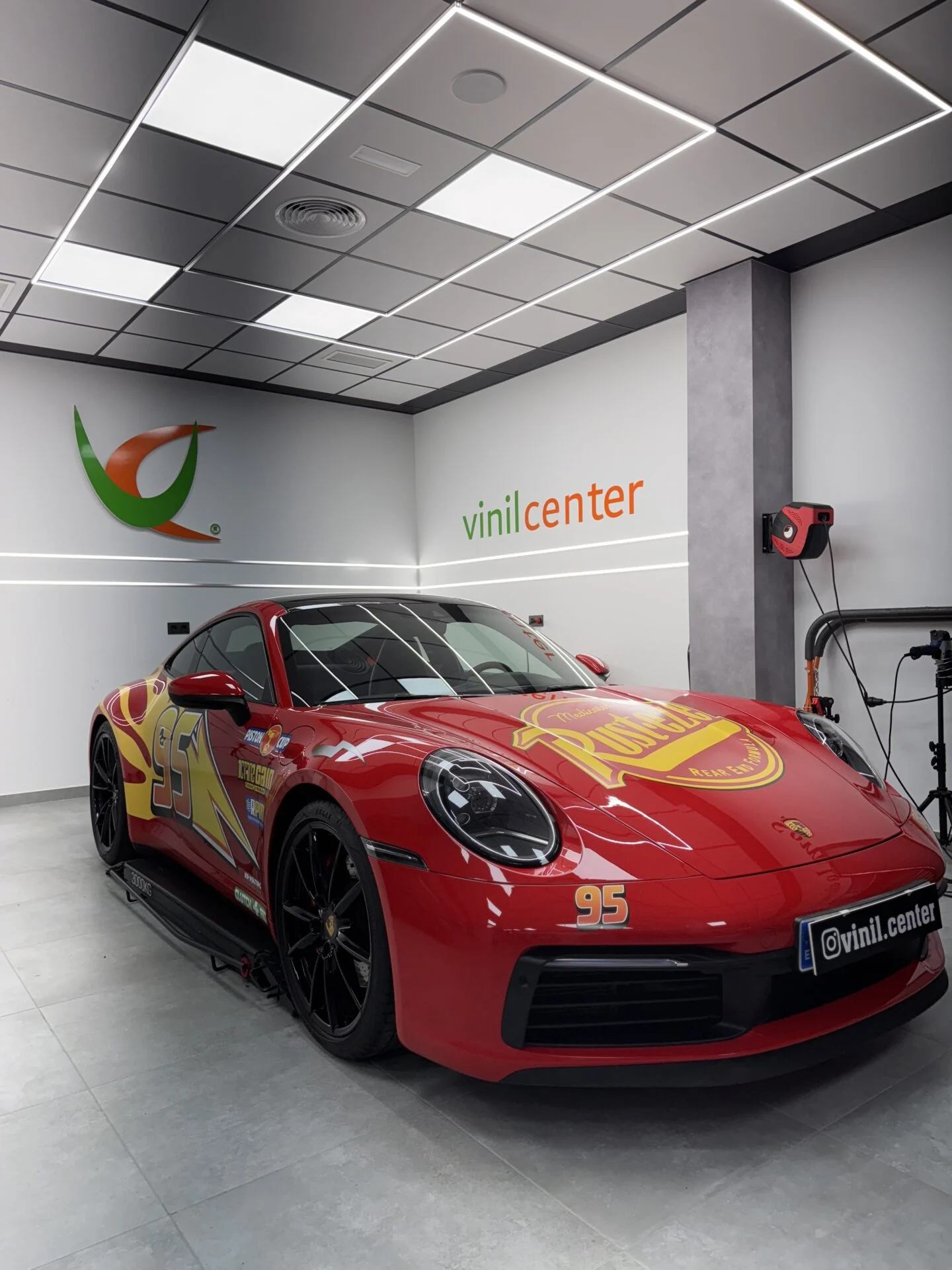 Porsche 911 rotulado en rojo con gráficas tipo Rayo McQueen